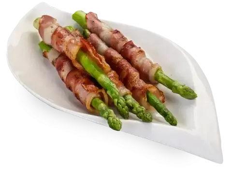 Bacon wrapped asparagus placed on a plate