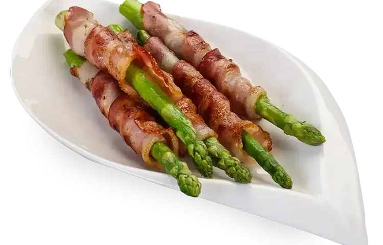 Bacon wrapped asparagus placed on a plate